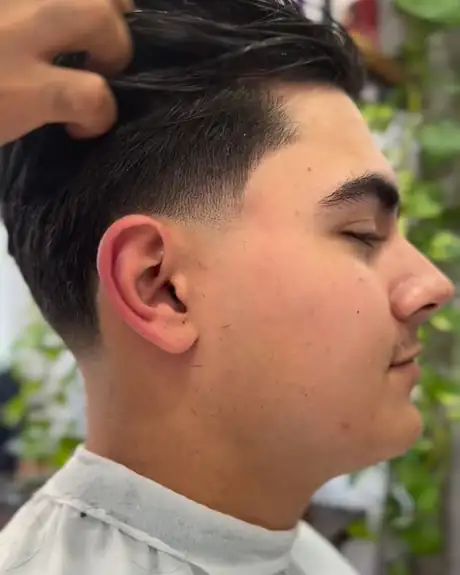 Slicked-back taper being finger-styled